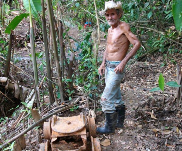 The landowner at the histroic Estralla Mine with the base of an old mining trolly dating from the 1930s